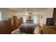 Spacious bedroom with king-size bed, ample wood furniture, and a ceiling fan at 487 Dawnview Sq, Port Orange, FL 32127