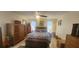 Spacious bedroom with king-size bed, ample wood furniture, and a ceiling fan at 487 Dawnview Sq, Port Orange, FL 32127