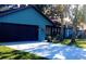 Newly painted teal home with dark brown garage doors and mature trees at 487 Dawnview Sq, Port Orange, FL 32127