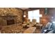 Cozy living room featuring stone fireplace and comfortable seating at 487 Dawnview Sq, Port Orange, FL 32127