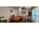 Home office with a large desk, two chairs, and ample natural light at 487 Dawnview Sq, Port Orange, FL 32127