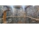 Large shower with marble walls, overhead shower head, and grab bar at 487 Dawnview Sq, Port Orange, FL 32127