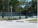 Community tennis court with parking area at 487 Dawnview Sq, Port Orange, FL 32127