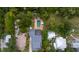 Aerial view showcasing a house with a pool and screened enclosure in a lush setting at 509 Faulkner St, New Smyrna Beach, FL 32168