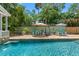 Refreshing pool with patio chairs and umbrellas at 509 Faulkner St, New Smyrna Beach, FL 32168