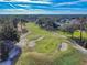 Aerial view of a golf course, with sand traps, putting green and manicured lawns at 55 Fairway Dr # 3D, Debary, FL 32713