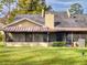 Backyard view of a home featuring a screened-in porch with a well maintained lawn and landscaping at 55 Fairway Dr # 3D, Debary, FL 32713