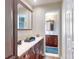 Bathroom featuring double vanity sinks, cherry cabinets, and a bright window at 55 Fairway Dr # 3D, Debary, FL 32713