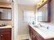 Bathroom featuring a well-lit vanity with cabinet storage, sink, and neutral decor at 55 Fairway Dr # 3D, Debary, FL 32713