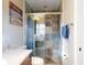 Bathroom with a tiled shower, glass door, and built-in bench seating at 55 Fairway Dr # 3D, Debary, FL 32713
