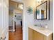 Bathroom vanity with decorative wall art and access to hallway and living area at 55 Fairway Dr # 3D, Debary, FL 32713