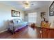 Comfortable bedroom with wood flooring and a bright window at 55 Fairway Dr # 3D, Debary, FL 32713