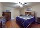 Cozy bedroom featuring wood floors, ceiling fan, and ample natural light at 55 Fairway Dr # 3D, Debary, FL 32713