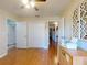 Bright bedroom with wood floors, a ceiling fan, and an ensuite bathroom, perfect for relaxation at 55 Fairway Dr # 3D, Debary, FL 32713