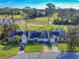 Aerial view of townhomes featuring lush landscaping, a golf course view, and driveway parking at 55 Fairway Dr # 3D, Debary, FL 32713