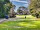 Personal playing on a lush green golf course; a second Personal is in a golf cart to the side at 55 Fairway Dr # 3D, Debary, FL 32713