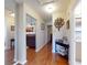 Hallway featuring hardwood floors, decorative accents and access to bathroom at 55 Fairway Dr # 3D, Debary, FL 32713