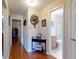 Hallway featuring hardwood floors and decorative accents, with access to bathroom at 55 Fairway Dr # 3D, Debary, FL 32713