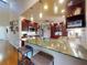 The kitchen has stainless steel appliances, ample storage space, and pendant lighting above barstool seating at 55 Fairway Dr # 3D, Debary, FL 32713