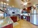 Updated kitchen with stainless steel appliances and a granite countertop peninsula overlooking the living room at 55 Fairway Dr # 3D, Debary, FL 32713