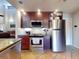 Kitchen featuring stainless steel appliances, tile floors, and stylish dark wood cabinets at 55 Fairway Dr # 3D, Debary, FL 32713