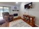 Comfortable living room with a fireplace, a ceiling fan, and sliding door access to the lanai at 55 Fairway Dr # 3D, Debary, FL 32713