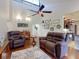 The living room has a fan, wood floors, vaulted ceilings, and a comfortable seating area at 55 Fairway Dr # 3D, Debary, FL 32713