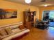 Cozy living room with futon and wooden shelving unit at 575 Lantern Ln, Orange City, FL 32763