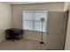 Bedroom with a desk, chair, floor lamp, and window with blinds at 600 Auburn Grove Ter, Auburndale, FL 33823