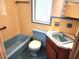 Bathroom with pale yellow tiled walls and blue fixtures at 600 S Montgomery Ave, Deland, FL 32720