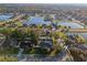 Aerial view of a lakefront home in a quiet residential neighborhood at 601 Autumn Fern Ln, Deland, FL 32720