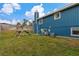 Blue house exterior with grassy backyard and playset at 63 St Anne Cir, Ormond Beach, FL 32176