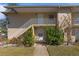 Condo exterior with walkway, stairs, and lush landscaping at 689 Wellington Station Blvd # 41, Ormond Beach, FL 32174