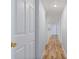 Long hallway with wood-look floors and white doors at 689 Wellington Station Blvd # 41, Ormond Beach, FL 32174