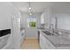 Bright kitchen with white cabinets, granite countertops, and stainless steel appliances at 689 Wellington Station Blvd # 41, Ormond Beach, FL 32174