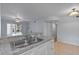 Open kitchen with granite countertops, stainless steel sink, and access to the living area at 689 Wellington Station Blvd # 41, Ormond Beach, FL 32174