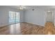 Living room with sliding glass doors and laminate floors at 689 Wellington Station Blvd # 41, Ormond Beach, FL 32174