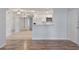 Open living room and kitchen area with wood-look floors at 689 Wellington Station Blvd # 41, Ormond Beach, FL 32174