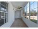 Bright sunroom with multiple windows, carpet, and a ceiling fan at 689 Wellington Station Blvd # 41, Ormond Beach, FL 32174