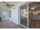 Spacious sunroom with sliding glass doors, carpet flooring, and ceiling fan at 689 Wellington Station Blvd # 41, Ormond Beach, FL 32174