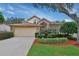 Brick house with two-car garage and well-manicured landscaping at 713 Powderhorn Cir, Lake Mary, FL 32746