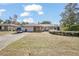 Brick ranch house with carport, landscaping, and large yard at 783 S Atmore Cir, Deltona, FL 32725
