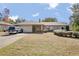 Brick ranch house with carport, landscaping, and large yard at 783 S Atmore Cir, Deltona, FL 32725
