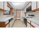View of kitchen with wood cabinets and appliances at 783 S Atmore Cir, Deltona, FL 32725