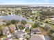 Scenic aerial view of lakeside community with lush greenery, manicured lawns and beautiful houses along the golf course at 10025 Scottish Pines Ct, Orlando, FL 32832
