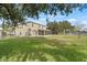 Large backyard offering a blend of green space and mature trees, perfect for outdoor enjoyment at 10025 Scottish Pines Ct, Orlando, FL 32832