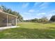 Screened patio overlooking a pond and grassy backyard at 10025 Scottish Pines Ct, Orlando, FL 32832