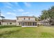 Expansive backyard featuring a screened porch, well-maintained lawn, and secure fencing at 10025 Scottish Pines Ct, Orlando, FL 32832