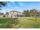 Large backyard with screen enclosed porch and fence overlooking a lake at 10025 Scottish Pines Ct, Orlando, FL 32832