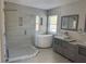 Elegant bathroom featuring a large walk-in shower, soaking tub, and modern vanity at 10025 Scottish Pines Ct, Orlando, FL 32832